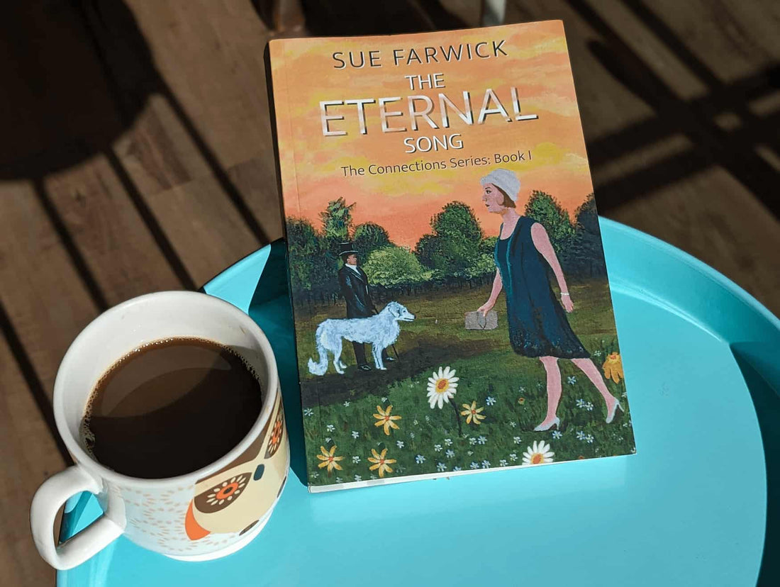 The Eternal Song by Sue Farwick for Tribus Press Book Cover on small table with a cup of coffee